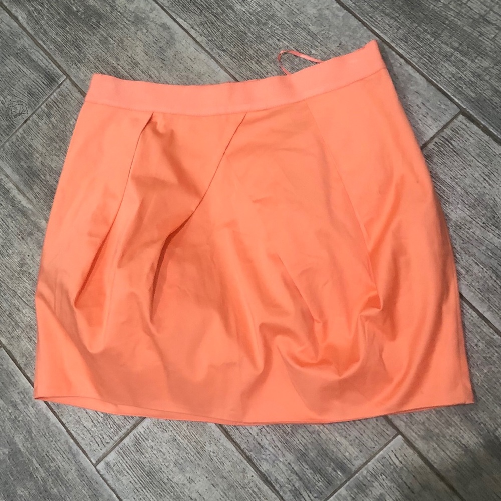Bright orange mini skirt.
